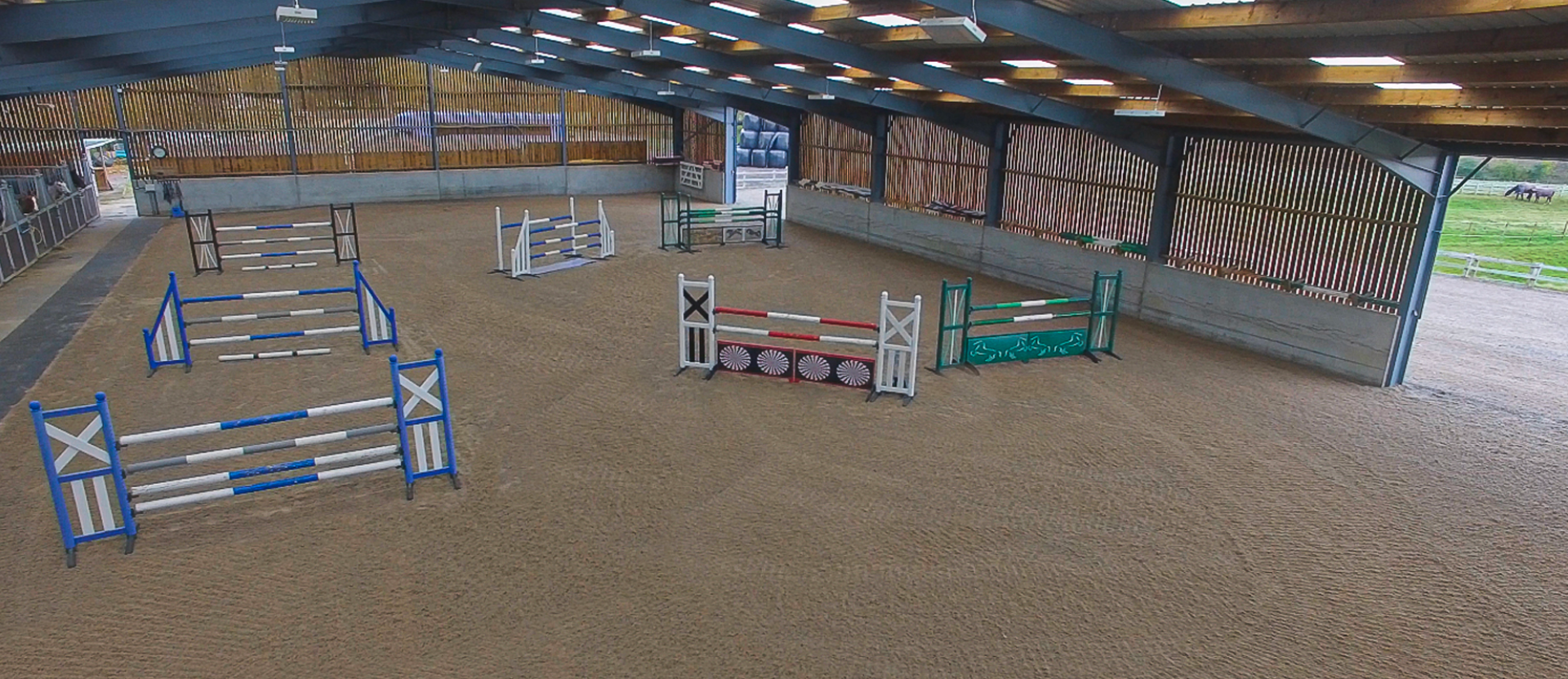 Horse riding arena with hurdles